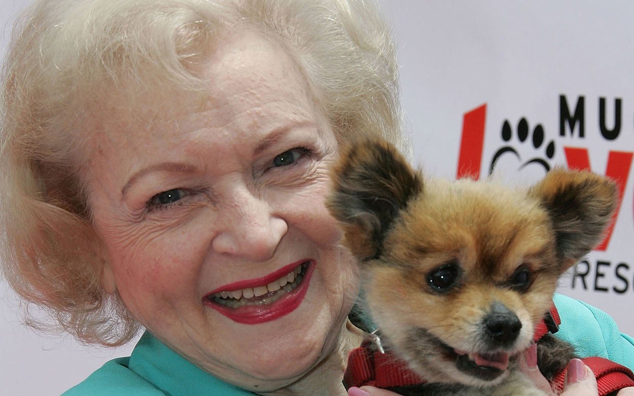 Betty White holding small dog