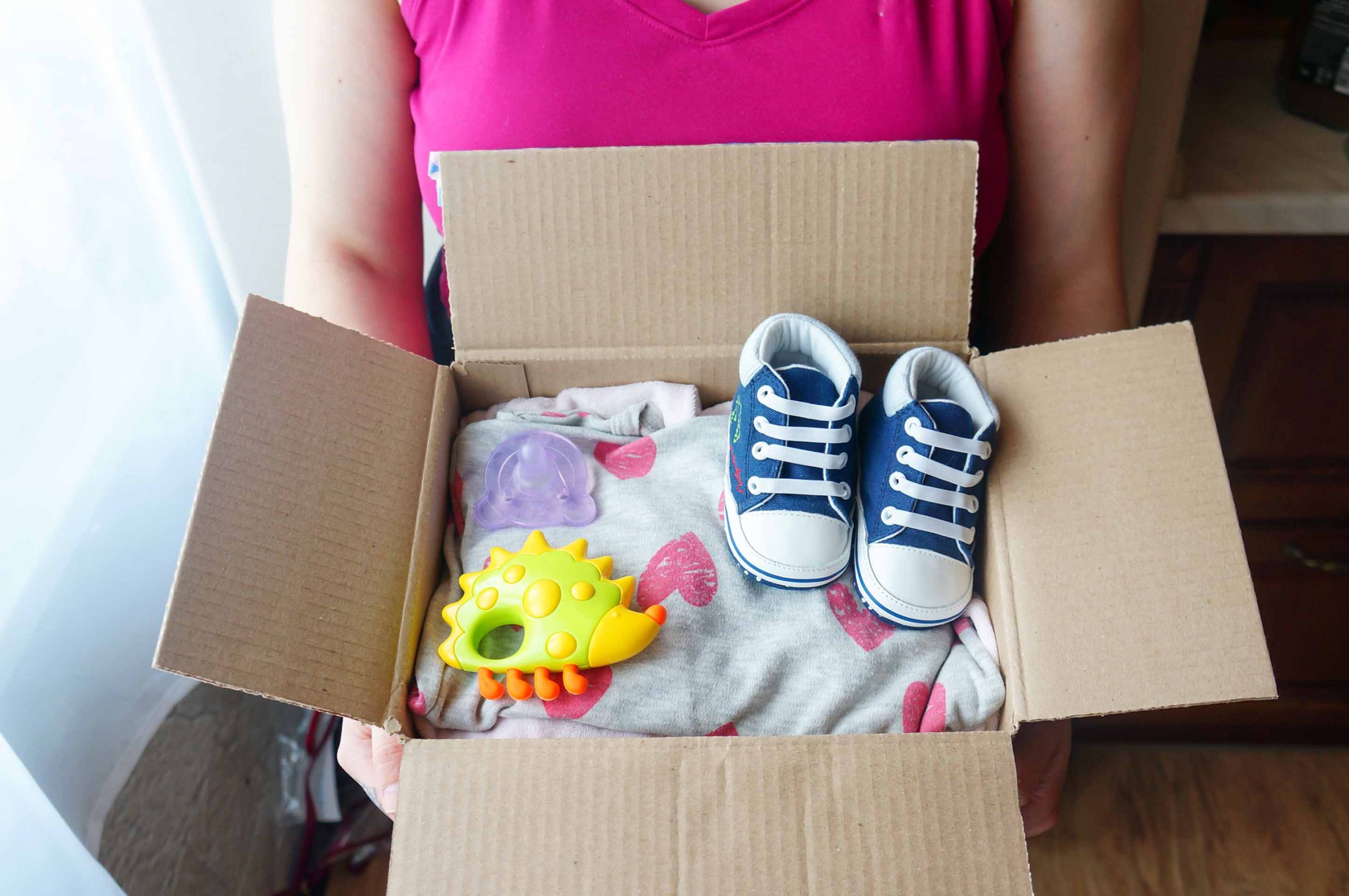 children's shoes, clothing and toys in box