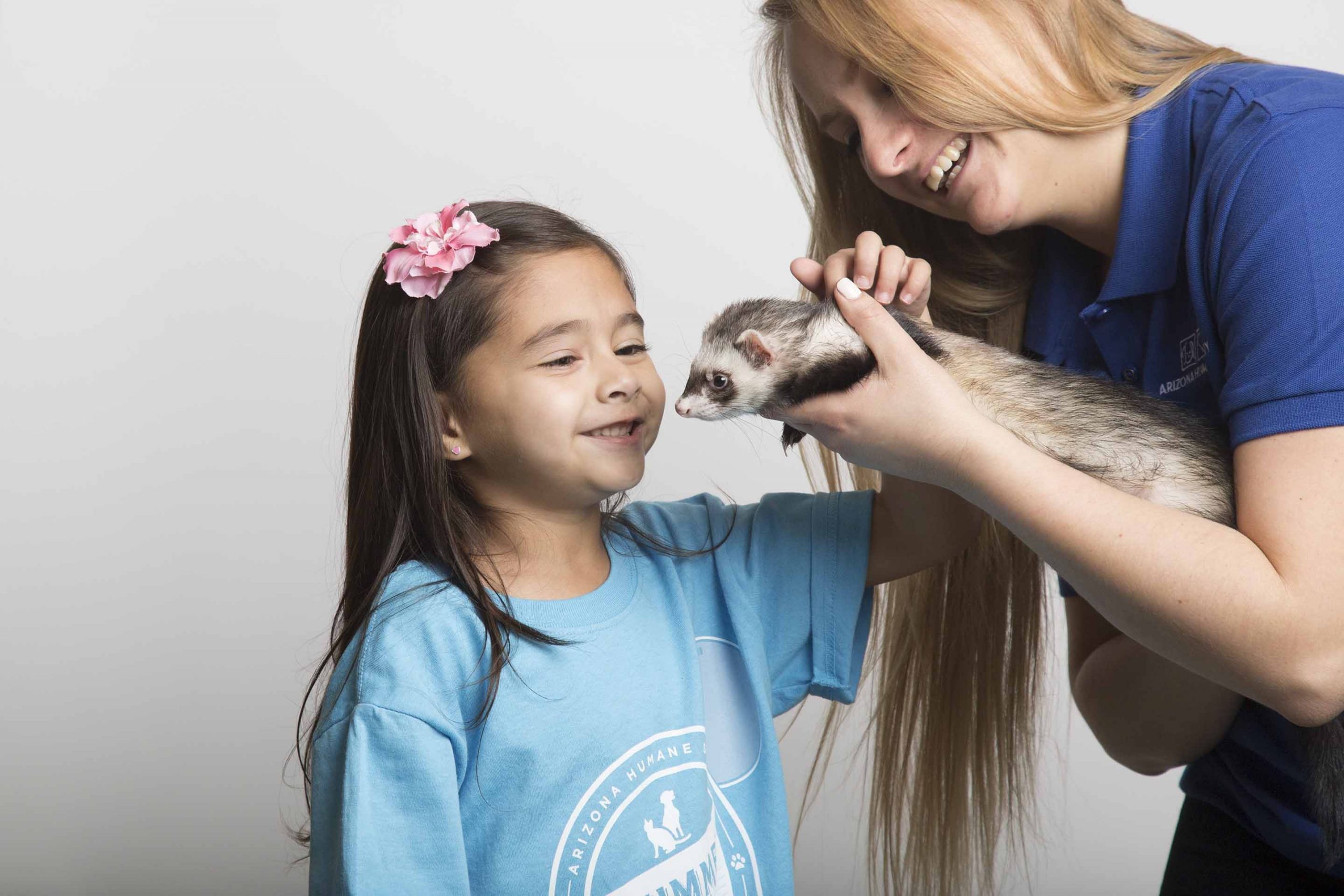 an AHS instructor shows a ferret to a child